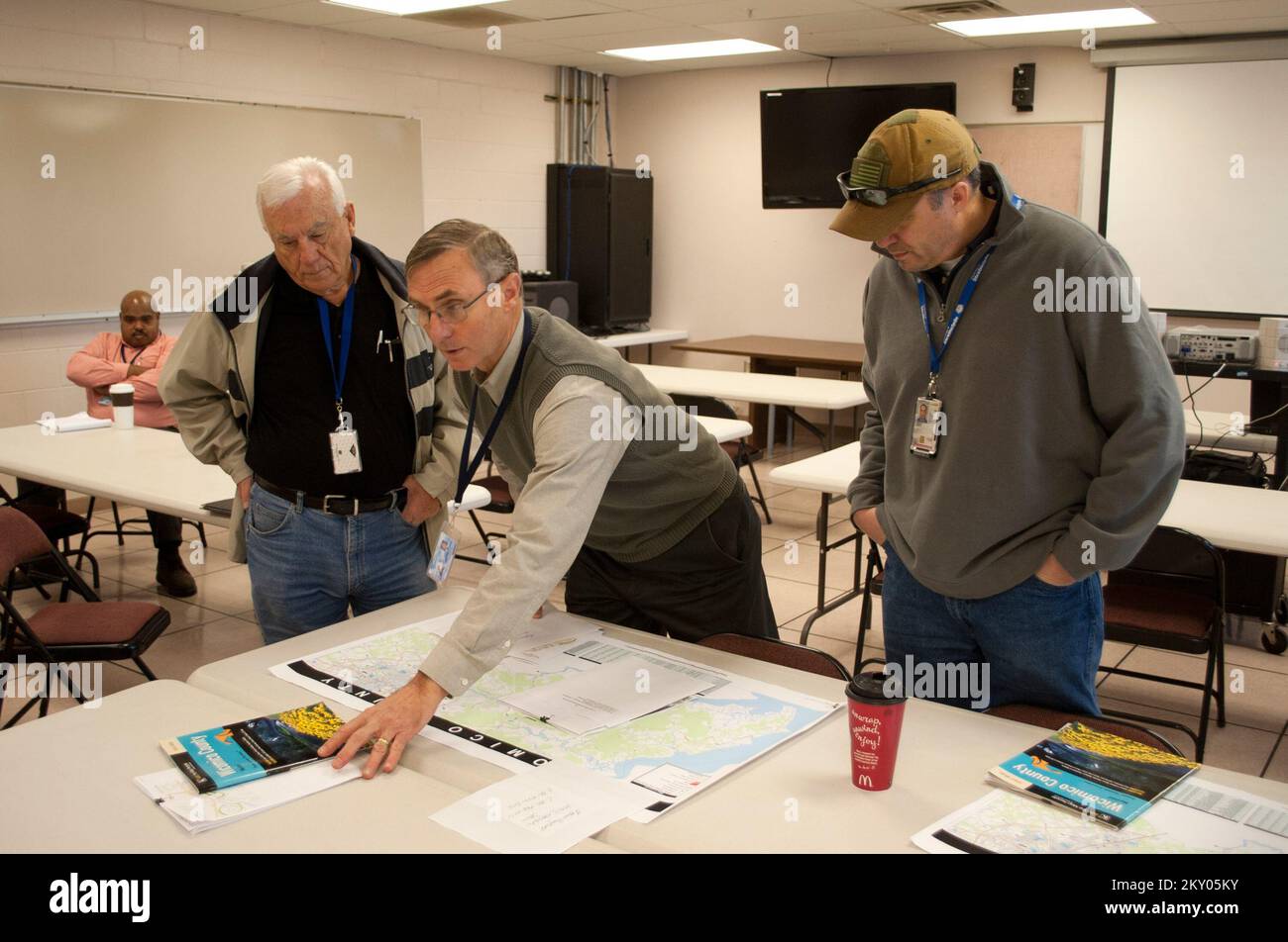 Salisbury, Md., Nov. 14, 2012   David Shipley, (center) director of the Wicomico County Emergency Services in Salisbury, MD, goes over damage reports from Hurricane Sandy with Duane Woodruff (left) ,Small Business Administration, and James Taylor (right), FEMA at the emergency services offices. FEMA and county officials were assessing the effects from Hurricane Sandy. Maryland Hurricane Sandy. Photographs Relating to Disasters and Emergency Management Programs, Activities, and Officials Stock Photo
