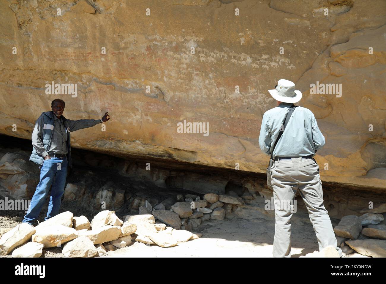 Archaeologists studying the prehistoric rock art at Quhaito in Eritrea Stock Photo