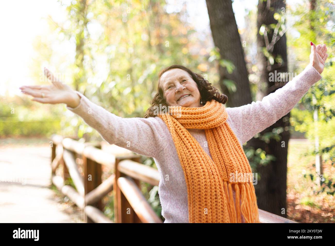 Happy old caucasian lady enjoying in nature. Wellness and outdoor