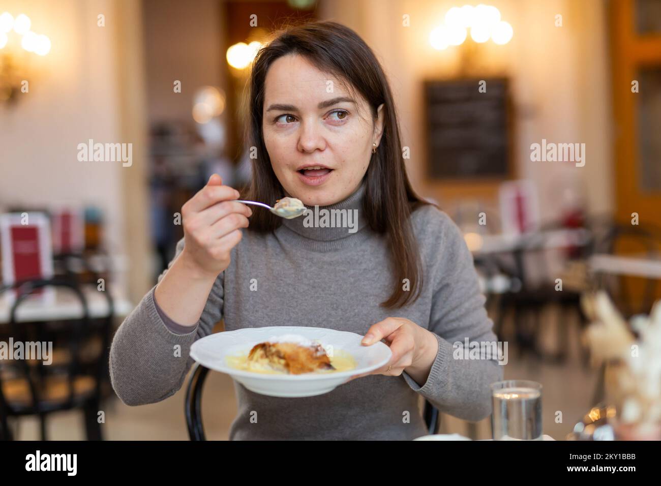 Woman tasting Viennese apple strudel during breakfast in cafe Stock ...