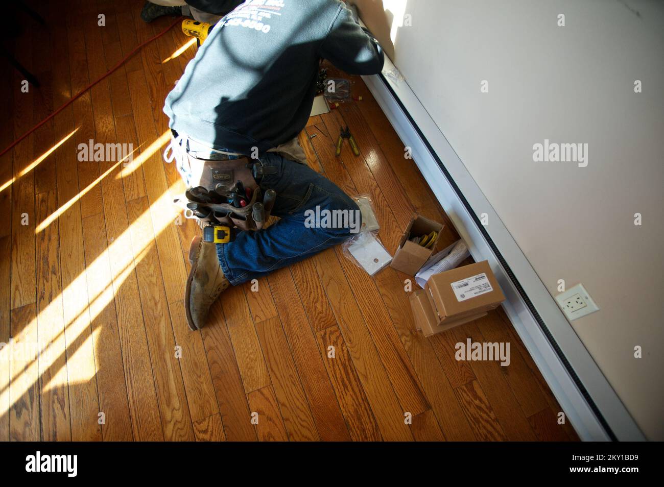 Long Beach, N.Y., Nov. 24, 2012   Electricians installing a heat register as part of the FEMA STEP Program. FEMA in conjunction with state, local and tribal partners, is implementing a Sheltering and Temporary Essential Power (STEP) Program to help people get back into their homes quickly and safely. STEP assists State, local and tribal governments in performing work and services essential to saving lives, protecting public health and safety, and protecting property. The program funds certain necessary and essential measures to help restore power, heat and hot water to primary residences that Stock Photo