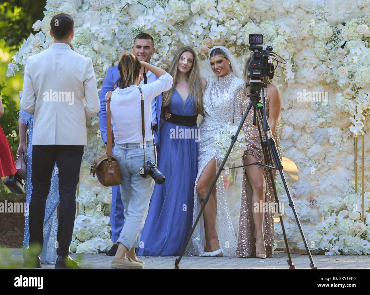 Dina Dragija taking pictures with guests during her wedding celebration