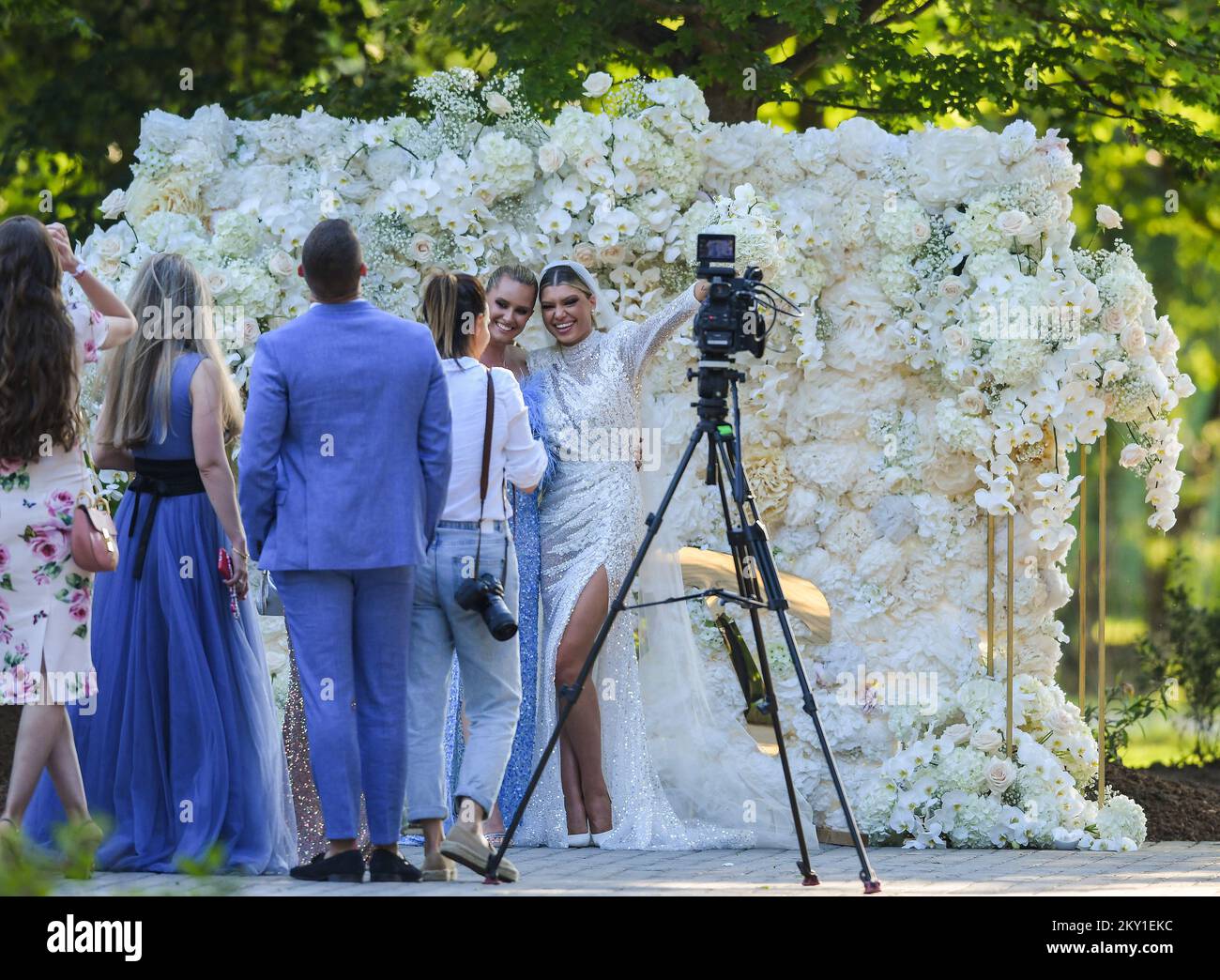 Dina Dragija taking pictures with guests during her wedding celebration