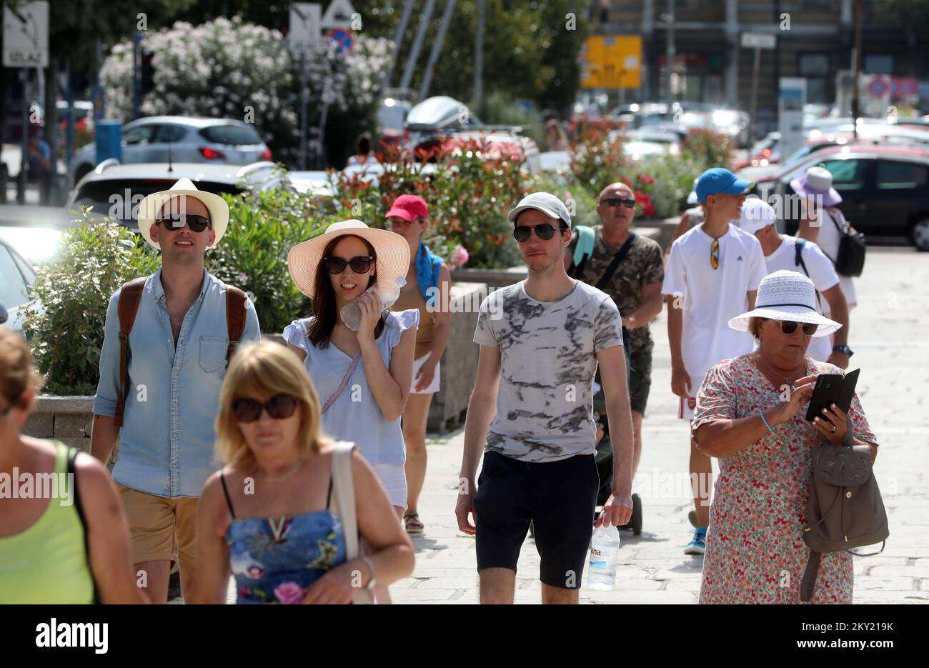 People walking along the city center during the first heat wave this year, in Rijeka, Croatia, on June 28, 2022. Photo: Goran Kovacic/PIXSELL  Stock Photo