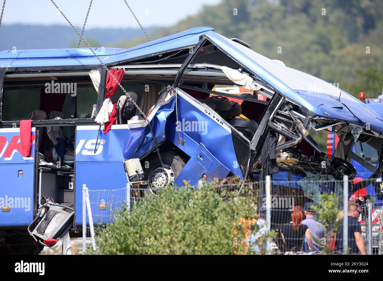 A crane works on removing the bus with Polish licence plates that slipped off a road, from the scene near Varazdin, northwestern Croatia, August 6, 2022. At least 12 people died and 31 injured after a Polish bus filled with religious pilgrims skidded off a highway in northern Croatia early on Saturday morning. 18 people among the 31 hurt have suffered serious injuries after the bus crashed off the A4 highway in Podvorec, about 30 miles (50km) north of capital Zagreb. Photo: Matija Habljak/PIXSELL Stock Photo