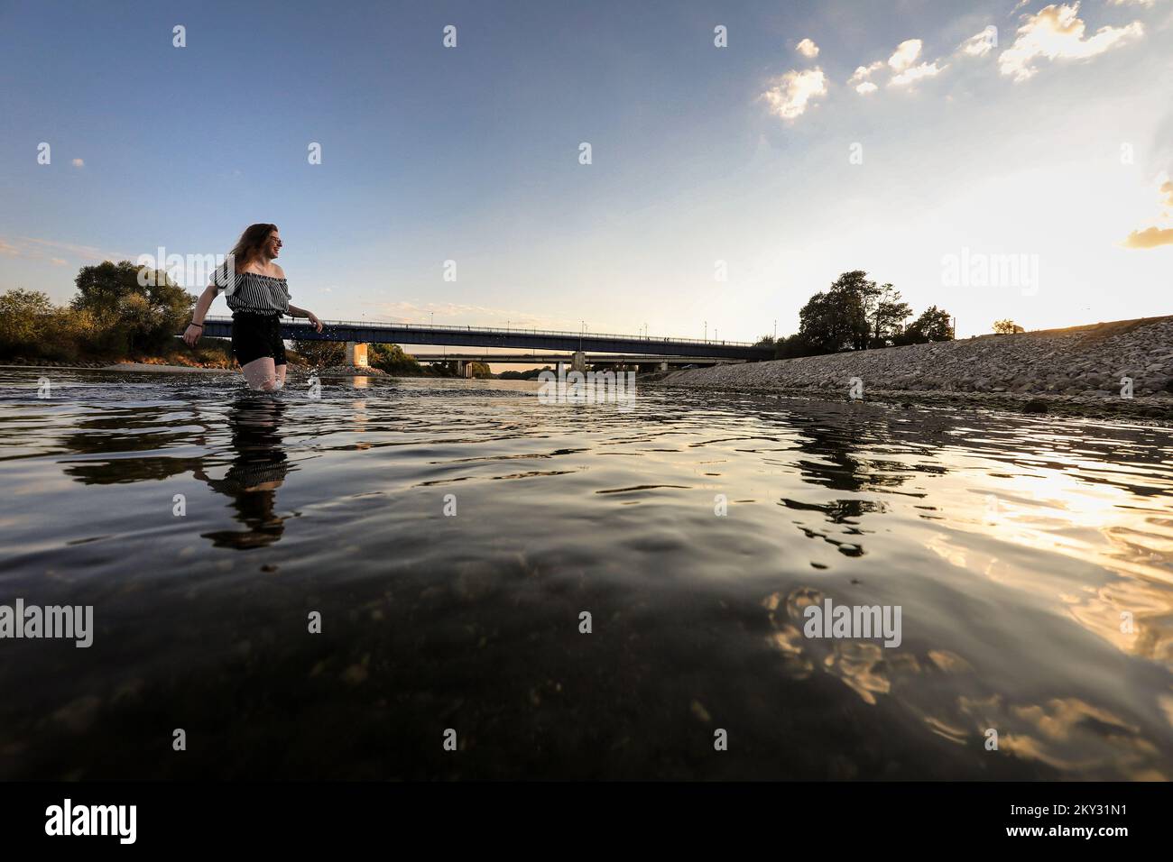 A young girl is having fun in the Sava river, which has a very low water level due to the severe drought that has prevailed in recent weeks in Zagreb, Croatia on August 10, 2022. Photo: Emica Elvedji/PIXSELL Stock Photo