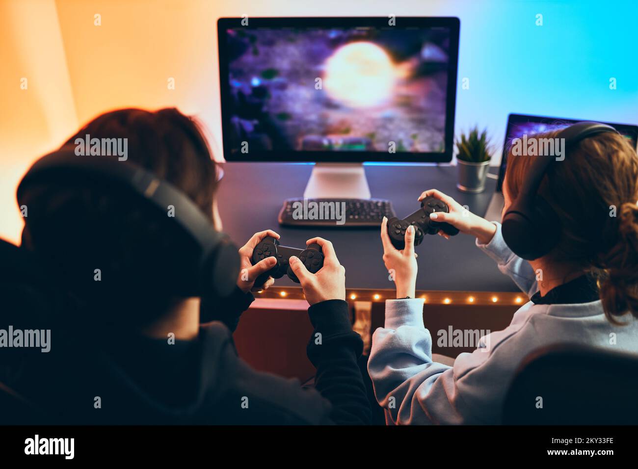 Gamer using controller to play online video games on computer. Man playing  game with joystick and headphones in front of monitor. Player having gaming  equipment, doing fun activity Stock Photo - Alamy