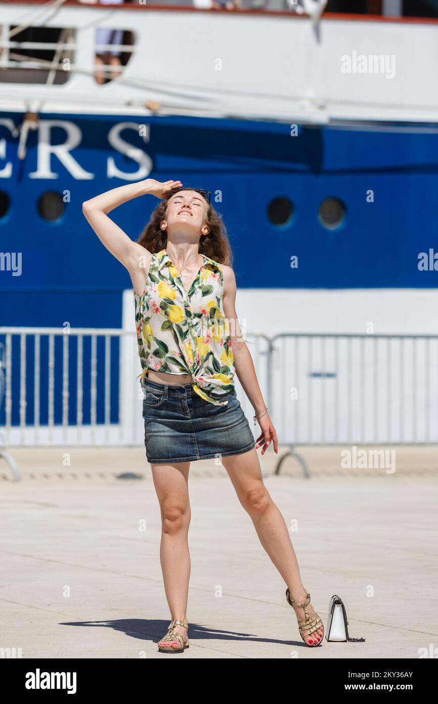 Woman posing in front of the Royal Clipper ship in Port of Zadar, in Zadar, Croatia, on Aug 21, 2022.Inspired by the tall ship Preussen, the Royal Clipper has the proud distinction of being the largest and only five-masted full-rigged sailing ship built since her predecessor was launched at the beginning of the last century. The vessel Royal Clipper is a Passenger (Cruise) Ship built in 2000 (22 years old) and currently sailing under the flag of Malta. Photo: Sime Zelic/PIXSELL Stock Photo