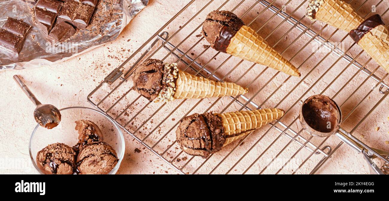 Chocolate ice cream on a metal rack with scoop from stainless stee, selective focus, close up Stock Photo