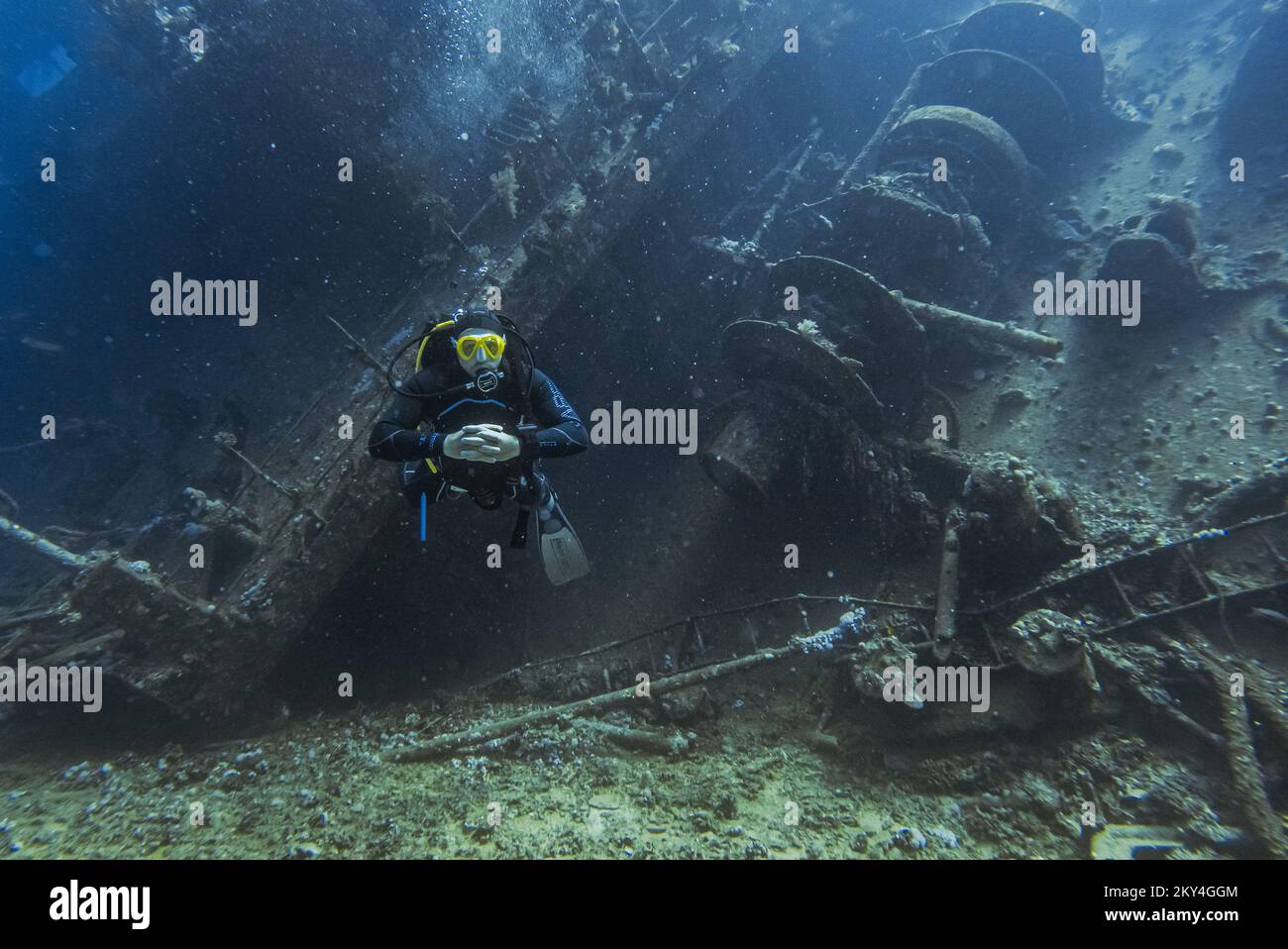 Scuba diver exploring the interior of a submerged wreck of Giannis D on September 30, 2022 in Hurghada, Red Sea, Egypt. In April 1983, Giannis D was loaded with lumber in Rijeka, Croatia, destined for Saudi Arabia and Yemen. The ship passed through the Mediterranean and through the Suez Canal. On 19 April 1983, it was approaching the Gobal Strait at full speed when it was seen to suddenly veer off course and crash heavily into the northwest corner of the Sha'ab Abu Nuhas ridge. The crew abandoned the ship and were safely rescued. The submerged wreck of Giannis D is located at a depth of 4 to 2 Stock Photo