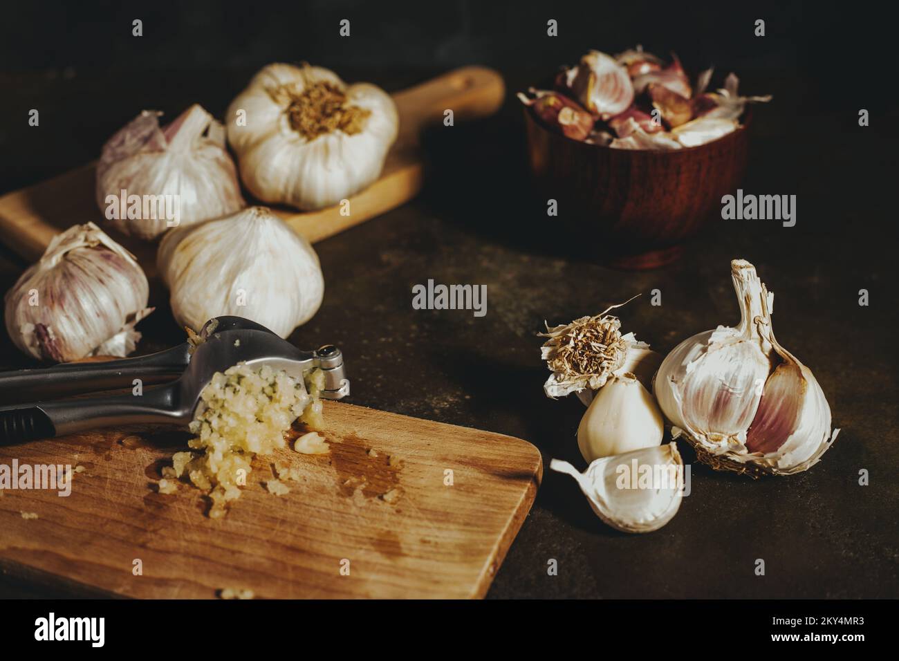 Garlic press with garlic cloves Stock Photo Alamy