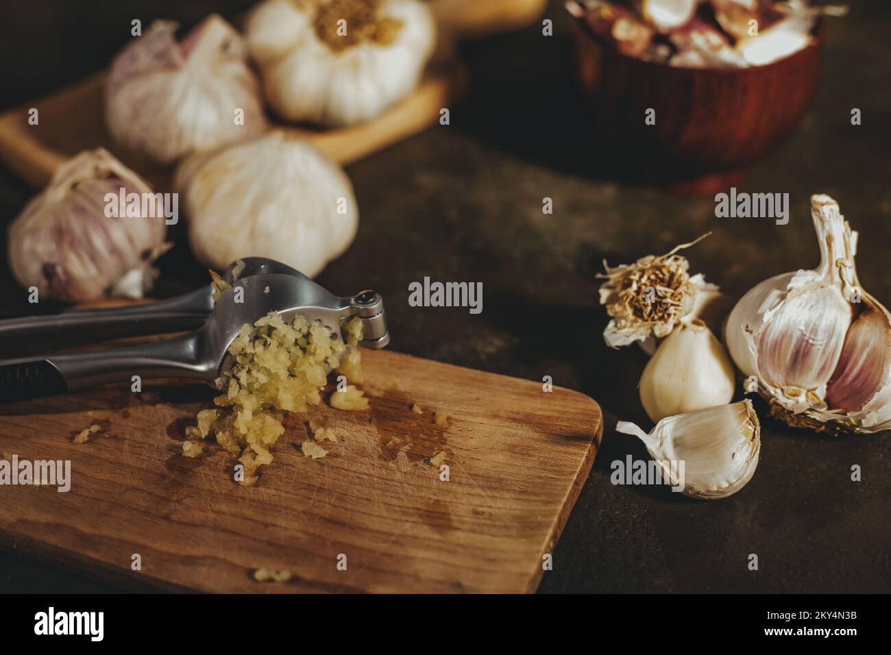 Garlic press with garlic cloves Stock Photo Alamy