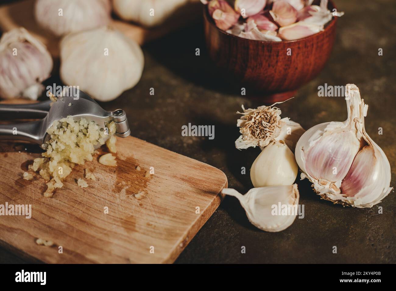 Garlic press with garlic cloves Stock Photo Alamy