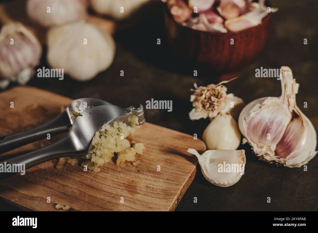 Garlic press with garlic cloves Stock Photo Alamy