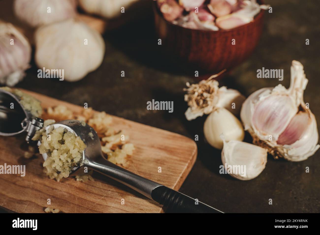 Garlic press with garlic cloves Stock Photo Alamy