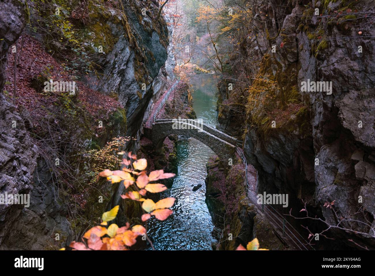 Gorges de l'Areuse, Noiraigue , Neuchatel, Switzerland, Europe. Romantic stone bridge over the river with autumn Jura mountains landscape. Stock Photo