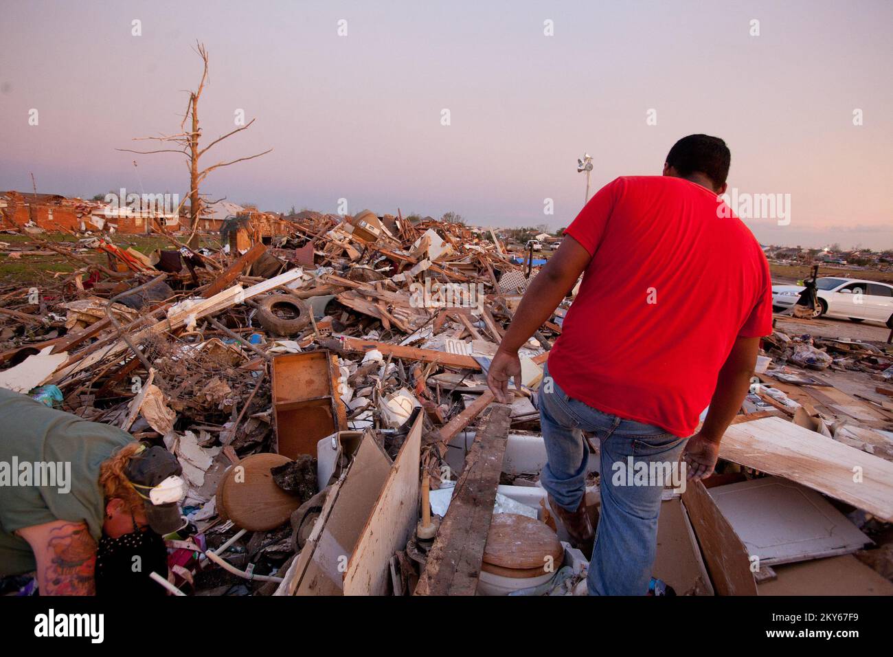 Moore, Okla., May 23, 2013   Moore residents, Kristian Parrish and Axel Gudina dig through the debris to find personal belongings. Moore was struck by an F5 tornado on May 20th. Andrea Booher/FEMA.. Photographs Relating to Disasters and Emergency Management Programs, Activities, and Officials Stock Photo