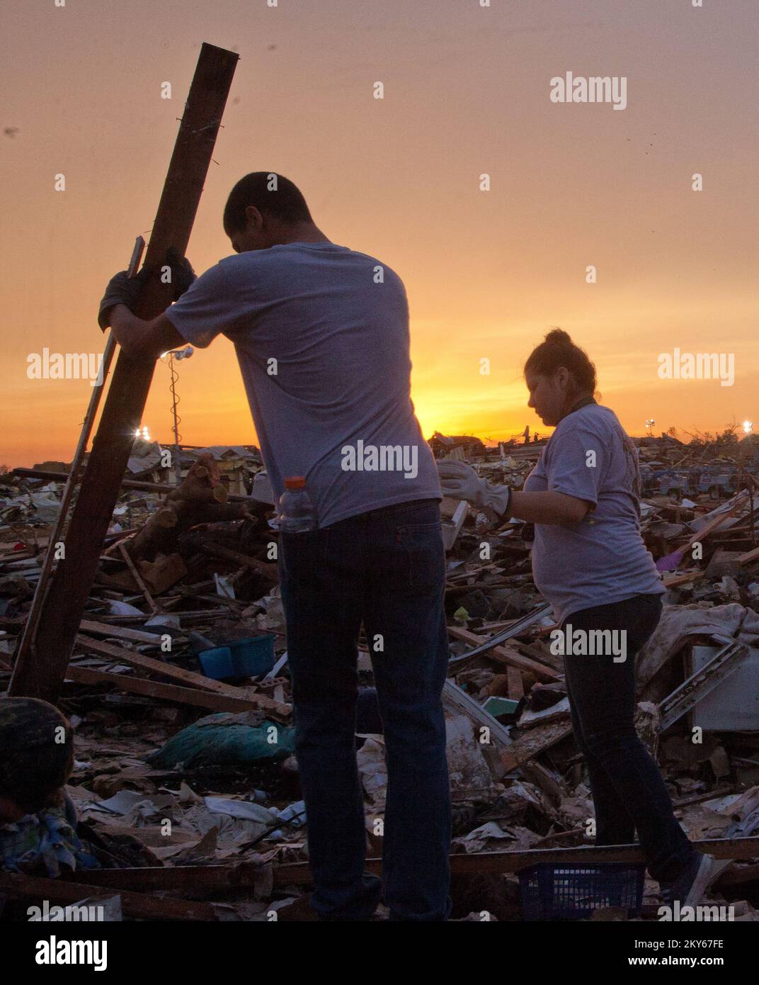 Moore, Okla., May 23, 2013   Moore residents move debris in search of a missing kitten. The Moore area was struck by a F5 tornado on May 20th. Andrea Booher/FEMA.. Photographs Relating to Disasters and Emergency Management Programs, Activities, and Officials Stock Photo
