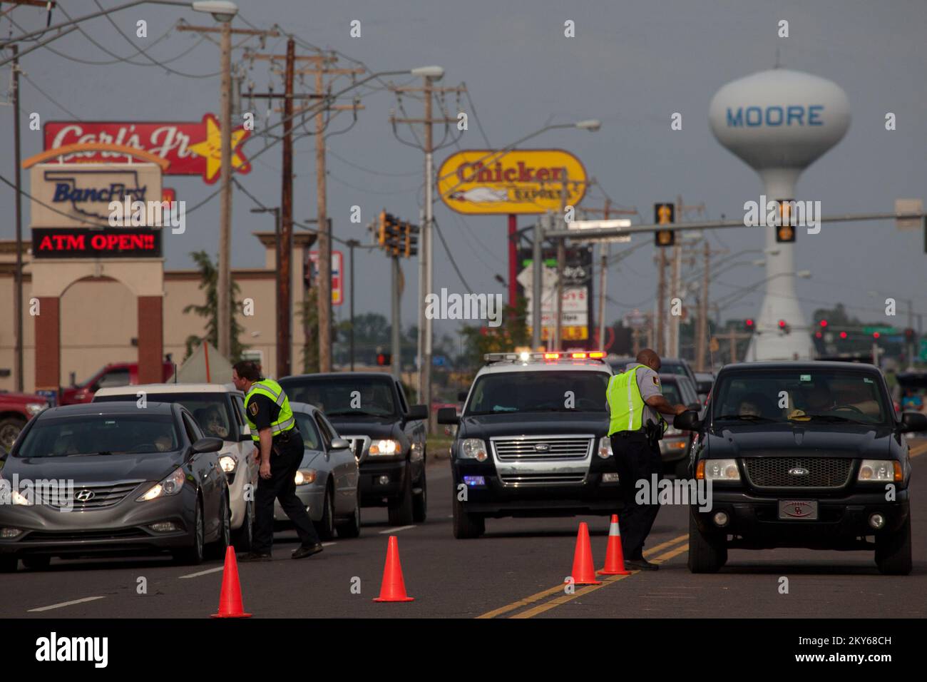 Moore, Okla., May 24, 2013   Law Enforcement Officers check credentials of people entering the tornado devastated area of Moore, Oklahoma. The Town of Moore was struck by a F5 tornado on May 20th. Andrea Booher/FEMA.. Photographs Relating to Disasters and Emergency Management Programs, Activities, and Officials Stock Photo