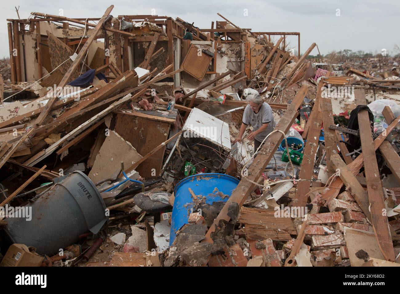 Moore, Okla., May 24, 2013   Moore resident, Wendy Gasaway searches through debris to find her belongings after a F5 tornado struck area. Andrea Booher/FEMA.. Photographs Relating to Disasters and Emergency Management Programs, Activities, and Officials Stock Photo