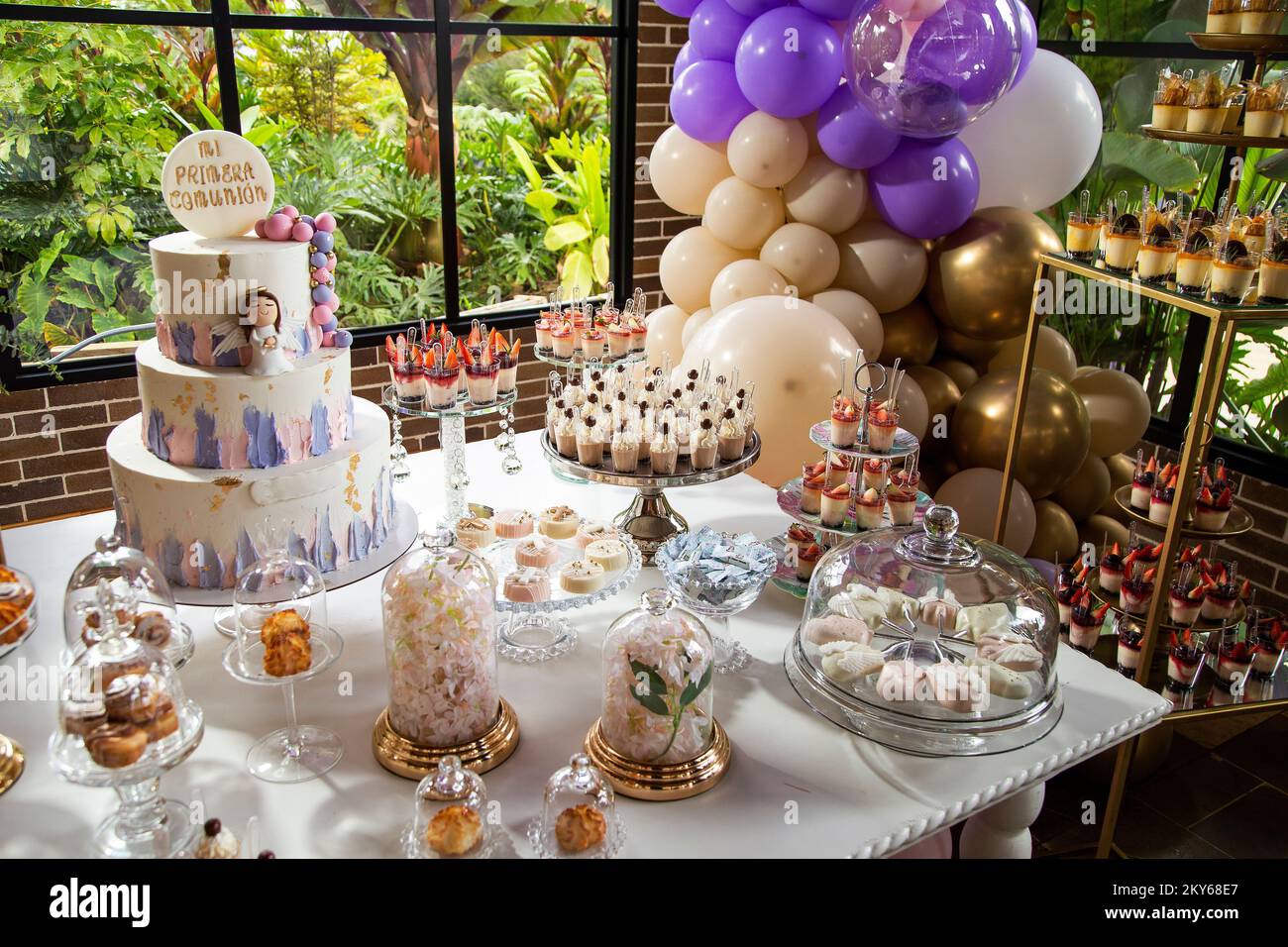 Table of desserts and sweets at the first communion party Design with