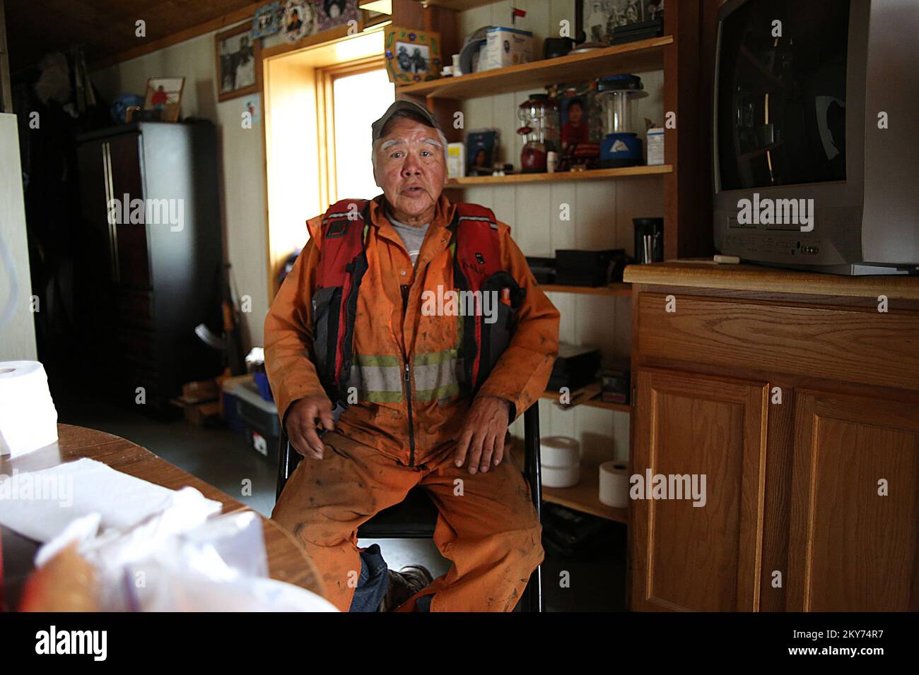 Hughes, Alaska, July 7, 2013   Disaster survivor Ralph Williams sits at his kitchen table while providing some narative regarding the losses caused from a severe flooding event along the Koyukuk riparian corridor. Individuals and business owners who sustained losses in the designated area can begin applying for assistance by registering at www.disasterassistance.gov or by calling 1-800-621-FEMA (3362). Adam Dubrowa/ FEMA.. Photographs Relating to Disasters and Emergency Management Programs, Activities, and Officials Stock Photo