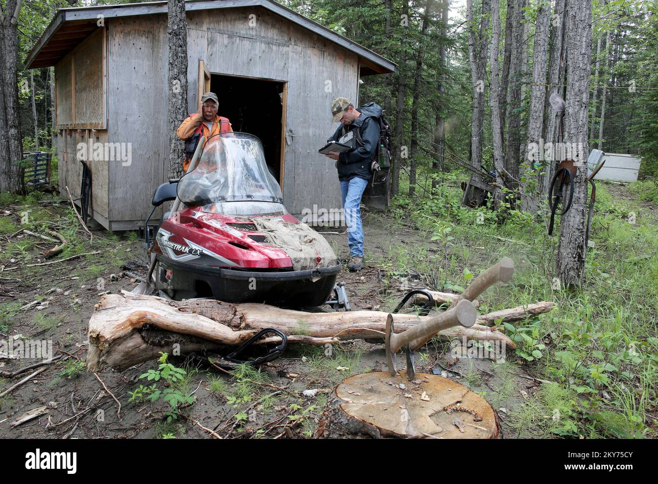 Hughes, Alaska, July 8, 2013   FEMA inspector Marty Williams is working with disaster survivor Ralph Williams in the remote areas of the Koyukuk River surveying the damages associated with severe flooding and ice jams that destroyed his personal property and home. Individuals and business owners who sustained losses in the designated area can begin applying for assistance by registering at www.disasterassistance.gov or by calling 1-800-621-FEMA (3362). Adam Dubrowa/ FEMA.. Photographs Relating to Disasters and Emergency Management Programs, Activities, and Officials Stock Photo