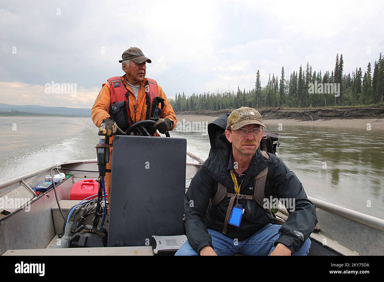 Hughes, Alaska, July 8, 2013   FEMA inspector Marty Williams is working with disaster survivor Ralph Williams in the remote areas of the Koyukuk River surveying the damages associated with severe flooding and ice jams that damaged his remote residence. Individuals and business owners who sustained losses in the designated area can begin applying for assistance by registering at www.disasterassistance.gov or by calling 1-800-621-FEMA (3362). Adam Dubrowa/ FEMA.. Photographs Relating to Disasters and Emergency Management Programs, Activities, and Officials Stock Photo