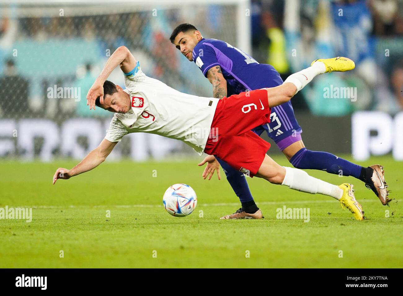 DOHA, QATAR - NOVEMBER 30: Player of Argentina Cristian Romero fights for the ball with player of Poland Robert Lewandowski during the FIFA World Cup Qatar 2022 group C match between Argentina and Poland at Stadium 974 on November 30, 2022 in Doha, Qatar. (Photo by Florencia Tan Jun/PxImages) Credit: Px Images/Alamy Live News Stock Photo