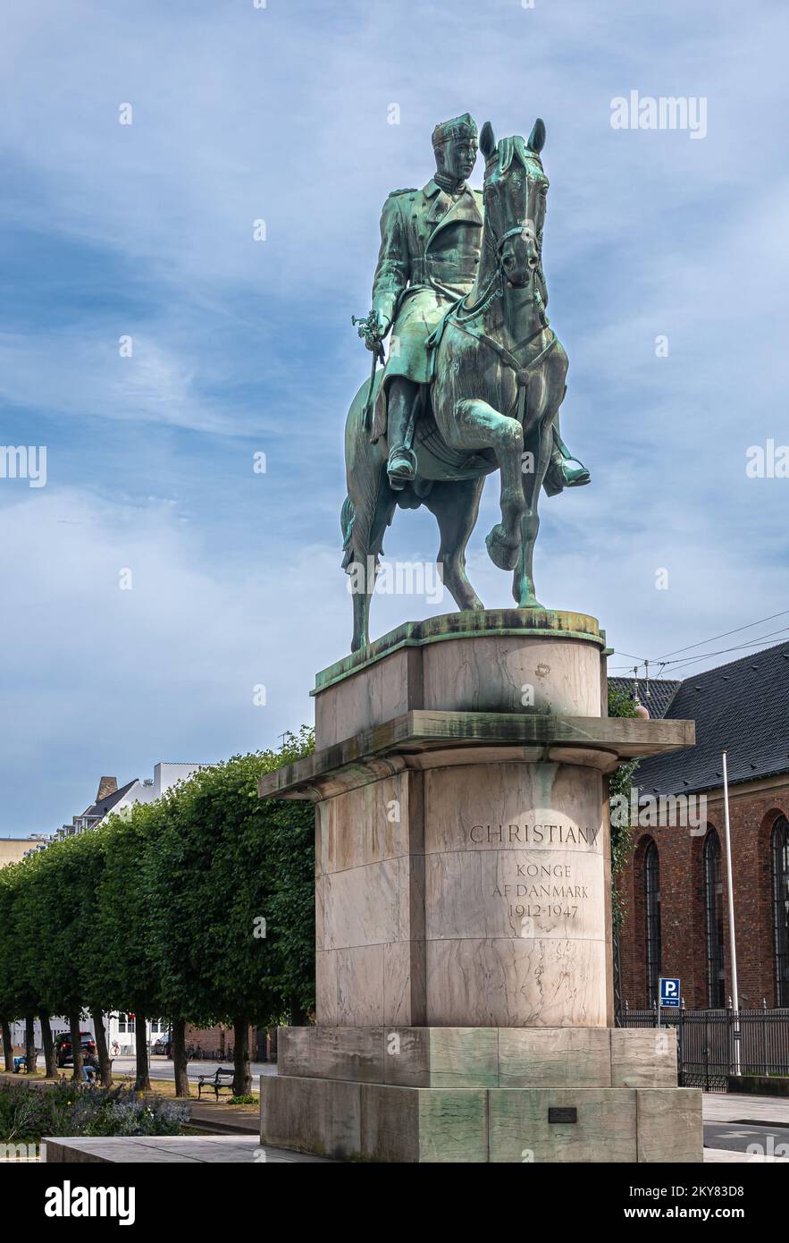 Copenhagen, Denmark - July 24, 2022: Closeup of King Christian X equestrian greenish bronze statue on beige stone pedestal at Saint Anna square under Stock Photo
