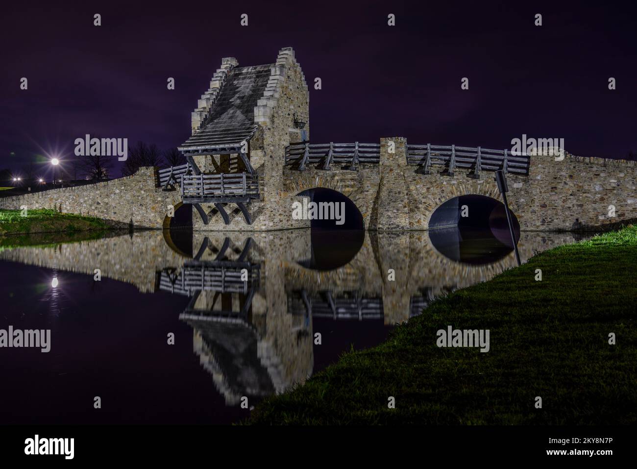 Stone bridge in Blount Cultural Park, at night with a reflection, in Montgomery, Alabama, USA. Stock Photo