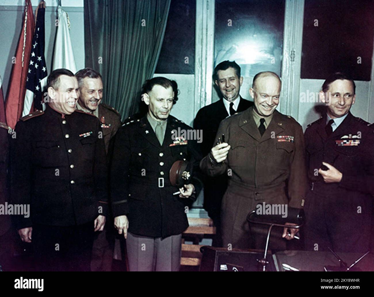 Soviet General Ivan Susloparov , British General Frederick E Morgan, US Army Lieutenant General Walter Bedell Smith ), US Navy Captain Harry C Butcher , US Army General Dwight Eisenhower  and British Marshal of the Royal Air Force Arthur Tedder as they celebrate soon after the German surrender during World War II, Rheims, France, May 7, 1945. Stock Photo