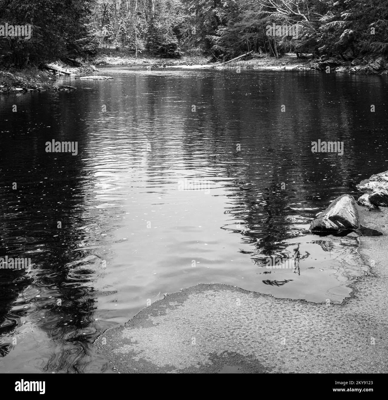 Black and white of snow dusted landscape by water Stock Photo Alamy