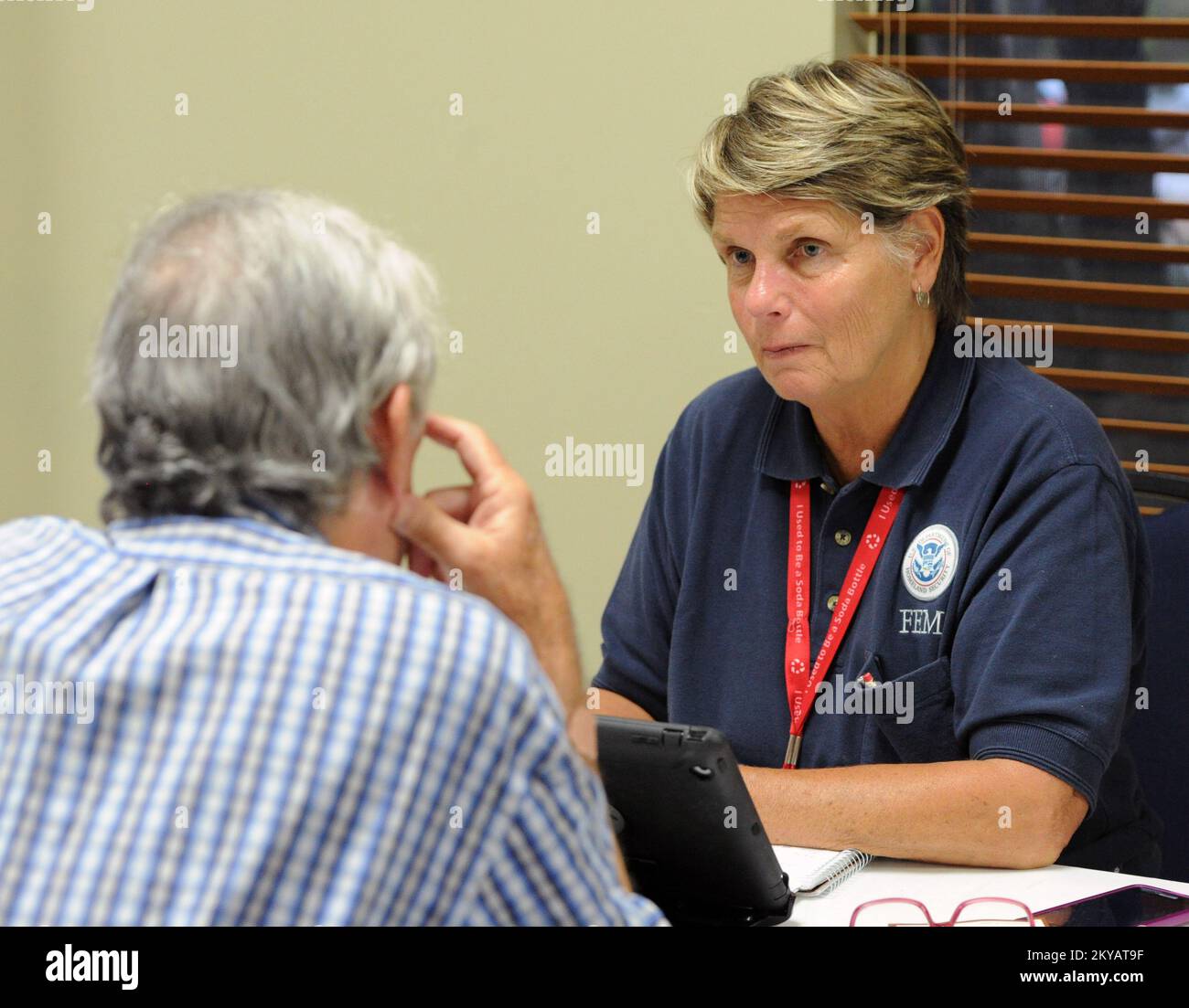 Wimberley, TX, June 4, 2015   Local residents speak to FEMA Specialists at the Mobile Disaster Registration Intake Center, located at the Community Center following a town hall meeting that addressed how to move forward with cleanup and registration for FEMA assistance. Jocelyn. Wimberley, TX, June 4, 2015 -- Local residents speak to FEMA specialists at the Mobile Disaster Registration Intake Center, located at the Community Center following a town hall meeting that addressed how to move forward with cleanup and registration for FEMA assistance.. Photographs Relating to Disasters and Emergency Stock Photo