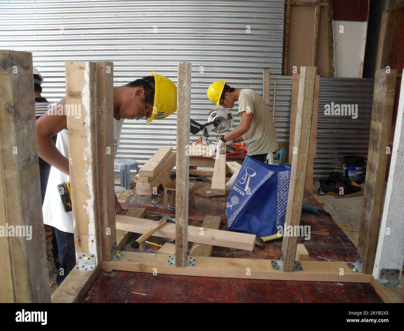 NMTI students constructing the hazard mitigation models with lumber, nails and metal fasteners supplied by True Value and ACE Hardware stores.. Saipan, CNMI 11/3/2015&nbsp; NMTI students constructing the hazard mitigation models with lumber, nails and metal fasteners supplied by True Value and ACE Hardware stores.. Photographs Relating to Disasters and Emergency Management Programs, Activities, and Officials Stock Photo