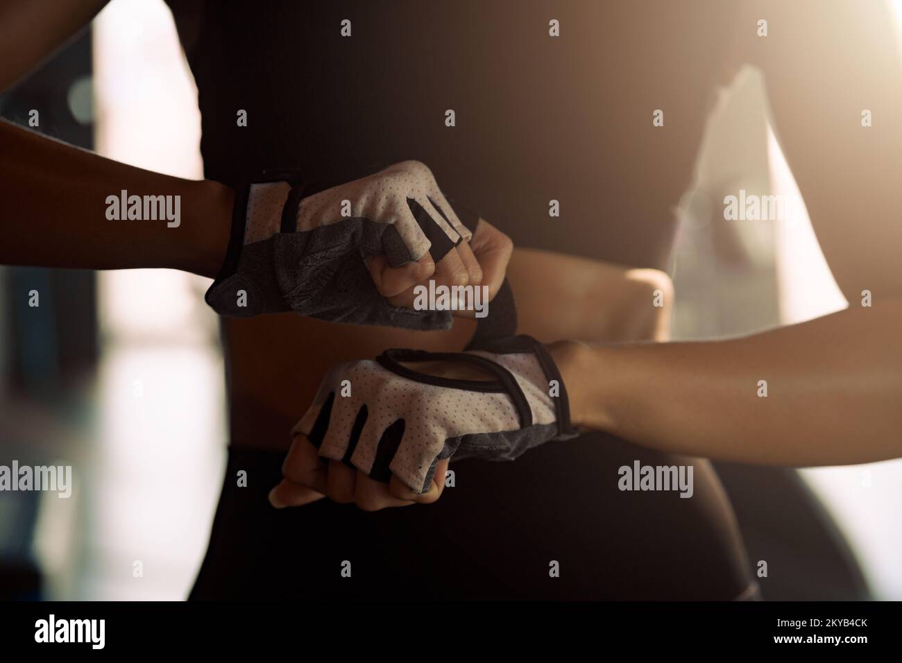 Woman put fitness gloves  for exercise at gym. Stock Photo