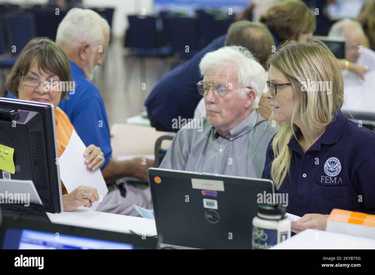 Wimberley, TX, USA August 26, 2015  Wimberley residents Gay and Mike Sullivan review flood mas representative Sarah Carrion at the Advisory Base Flood Elevation community meeting. Local, State and FEMA representatives were at the meeting to assist and advise homeowners about flood ma updates. Andrea. Texas Severe Storms, Tornadoes, Straight-line Winds, and Flooding. Photographs Relating to Disasters and Emergency Management Programs, Activities, and Officials Stock Photo