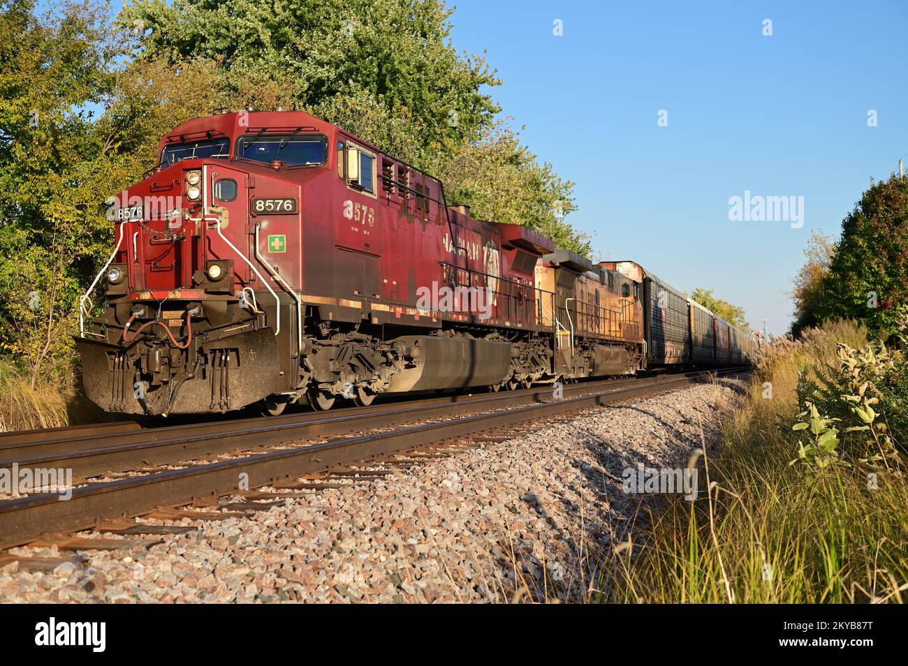 Bartlett, Illinois, USA. A pair of locomotives including a run through Union Pacific Railroad unit, power a freight train through Illinois. Stock Photo