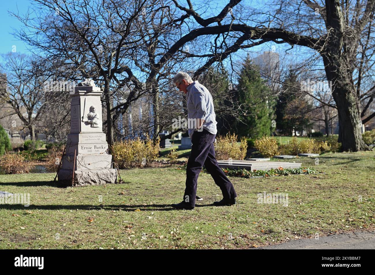 Chicago, Illinois, USA. A mourner paying his respects at the tombstone and grave site of famed Chicago Cubs baseball star Ernie Banks. Stock Photo