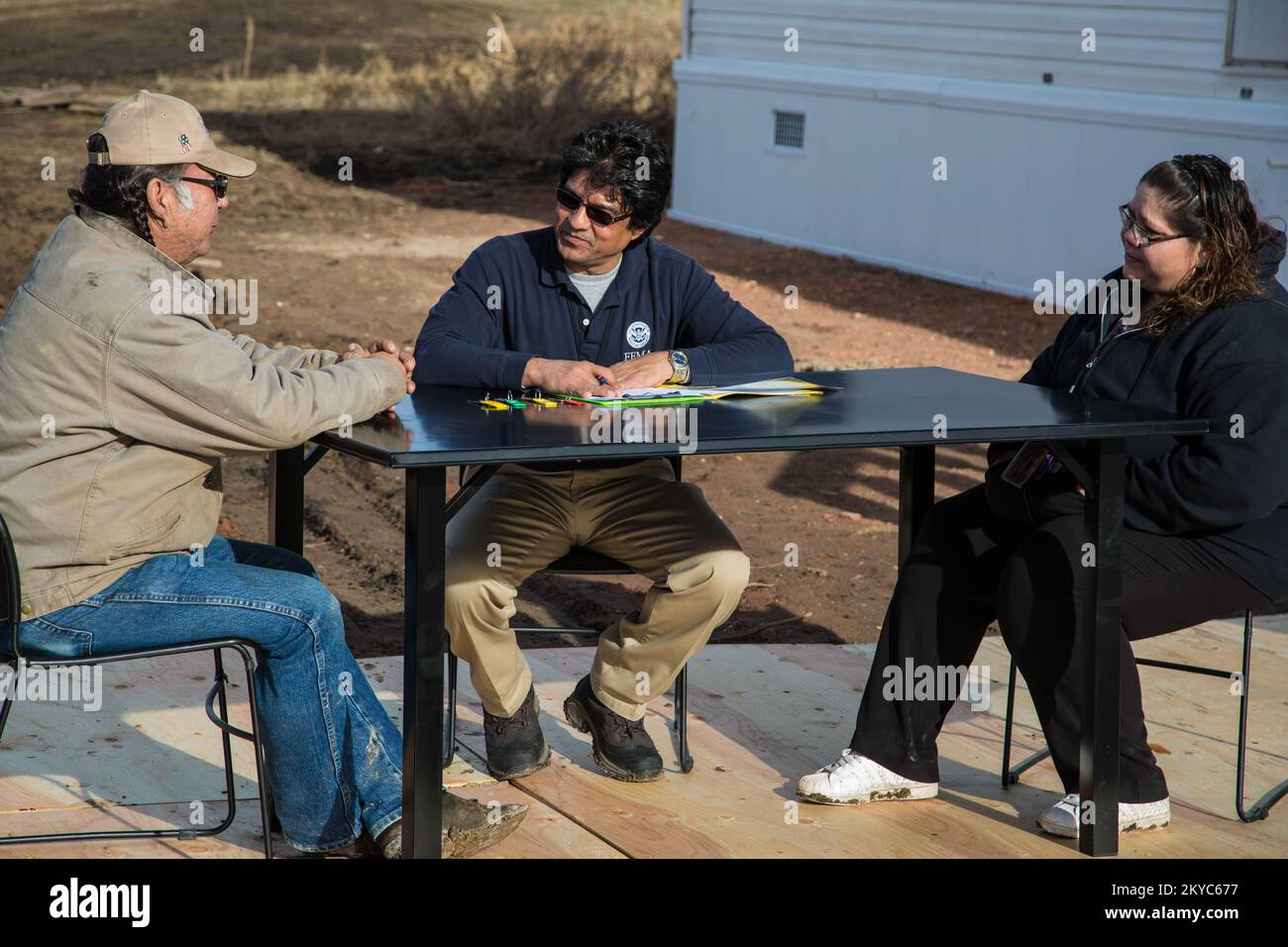 An Oglala Sioux Tribe disaster survivor (left) receives the title and