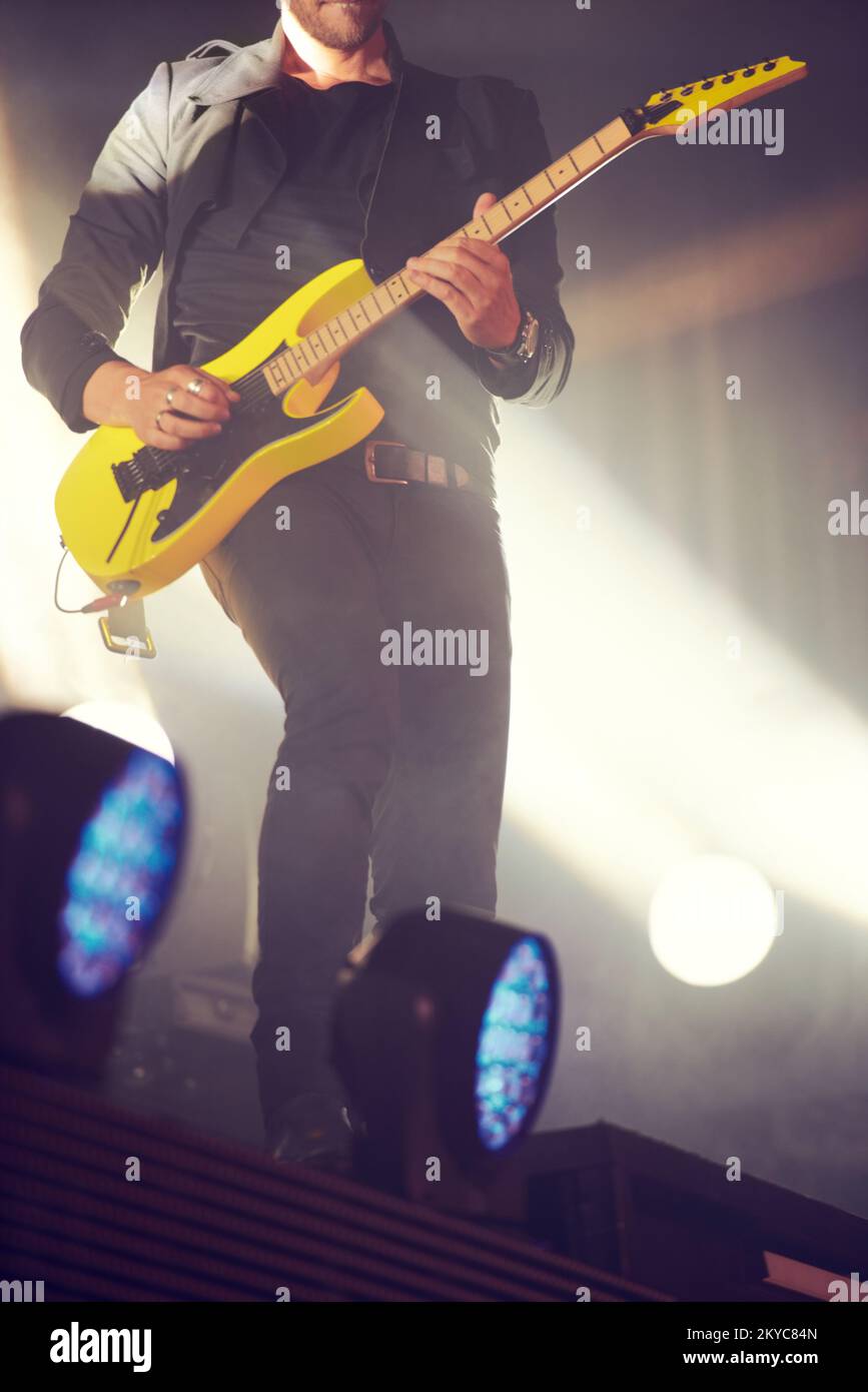 Presenting the Guitar Hero. a musician performing a guitar solo on the