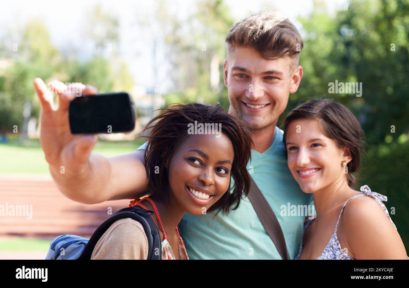 Connect with other students who want to get somewhere in life too - College application advertisements. A group of students taking a self-portrait on Stock Photo