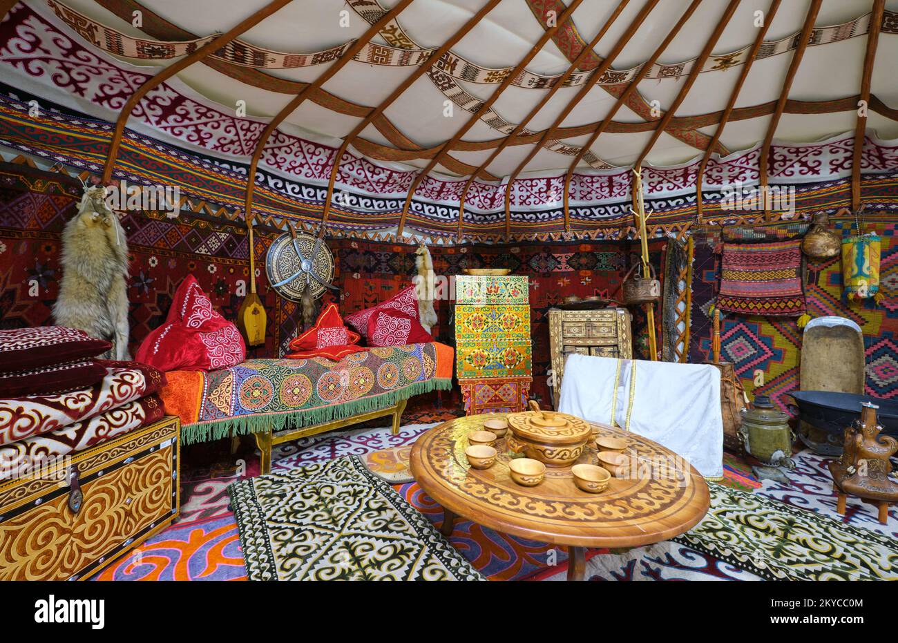 An interior view of a typical yurt, complete with rugs, carpets, clothes and other home posessions. At the Local History Museum in Karaganda, Kazakhst Stock Photo
