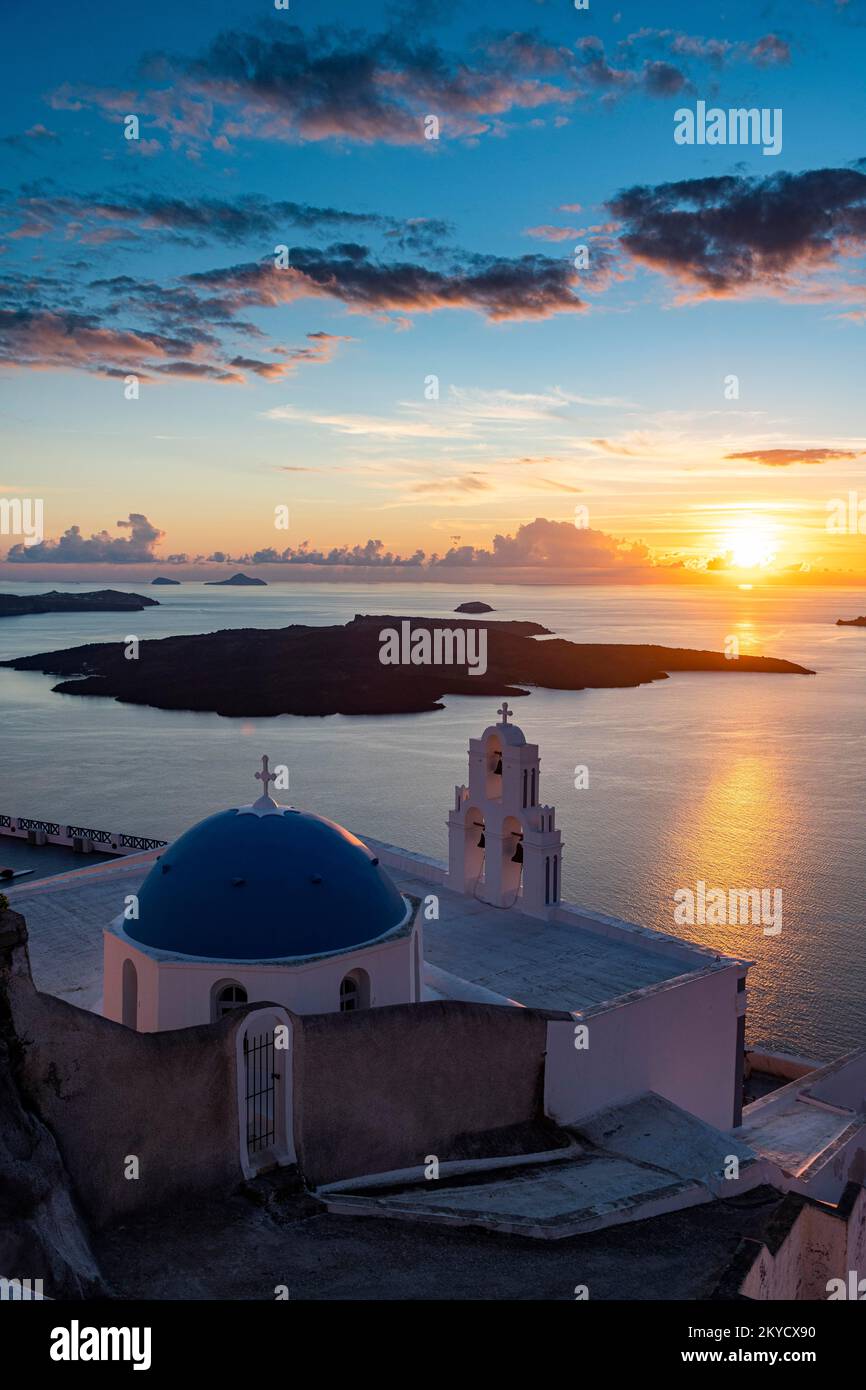 Sunset over the volcanic islands of Santorini and Anastasi Orthodox Church at sunset, Fira, Santorini, Greece Stock Photo