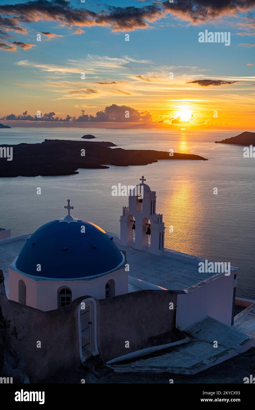 Sunset over the volcanic islands of Santorini and Anastasi Orthodox Church at sunset, Fira, Santorini, Greece Stock Photo