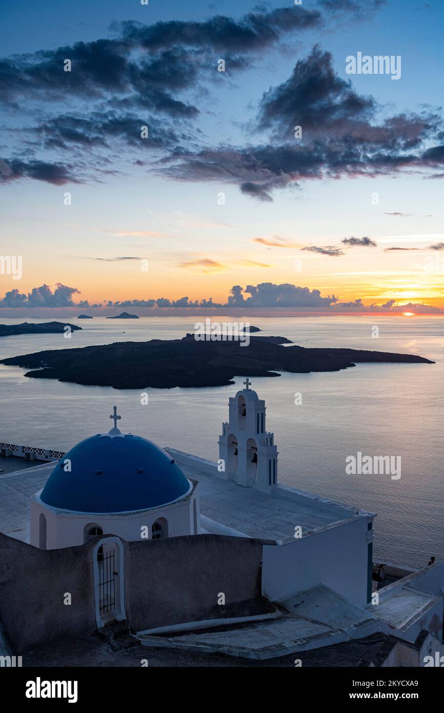 Sunset over the volcanic islands of Santorini and Anastasi Orthodox Church at sunset, Fira, Santorini, Greece Stock Photo