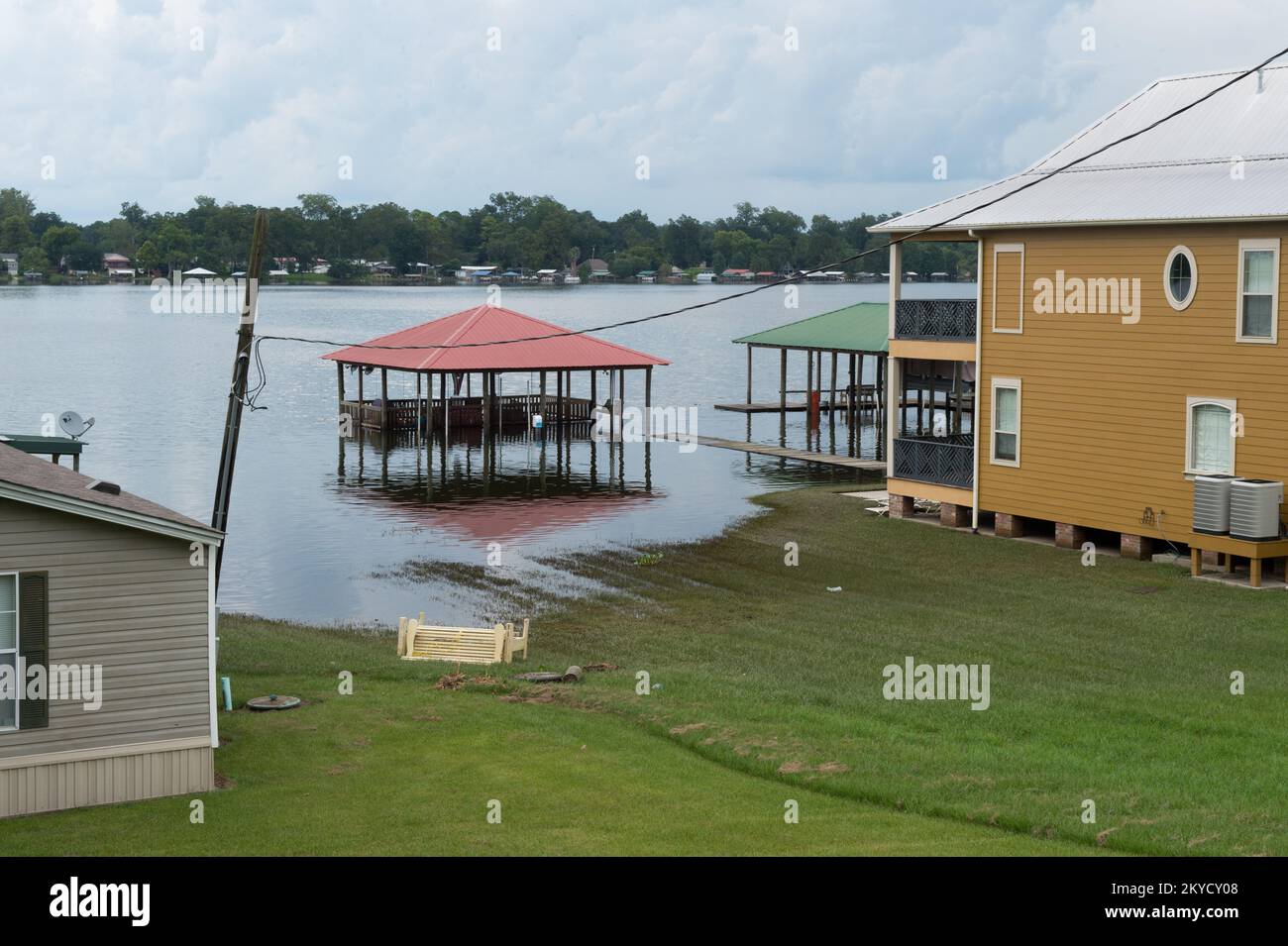 Floodwater covers a residential dock and dockhouse in the False River