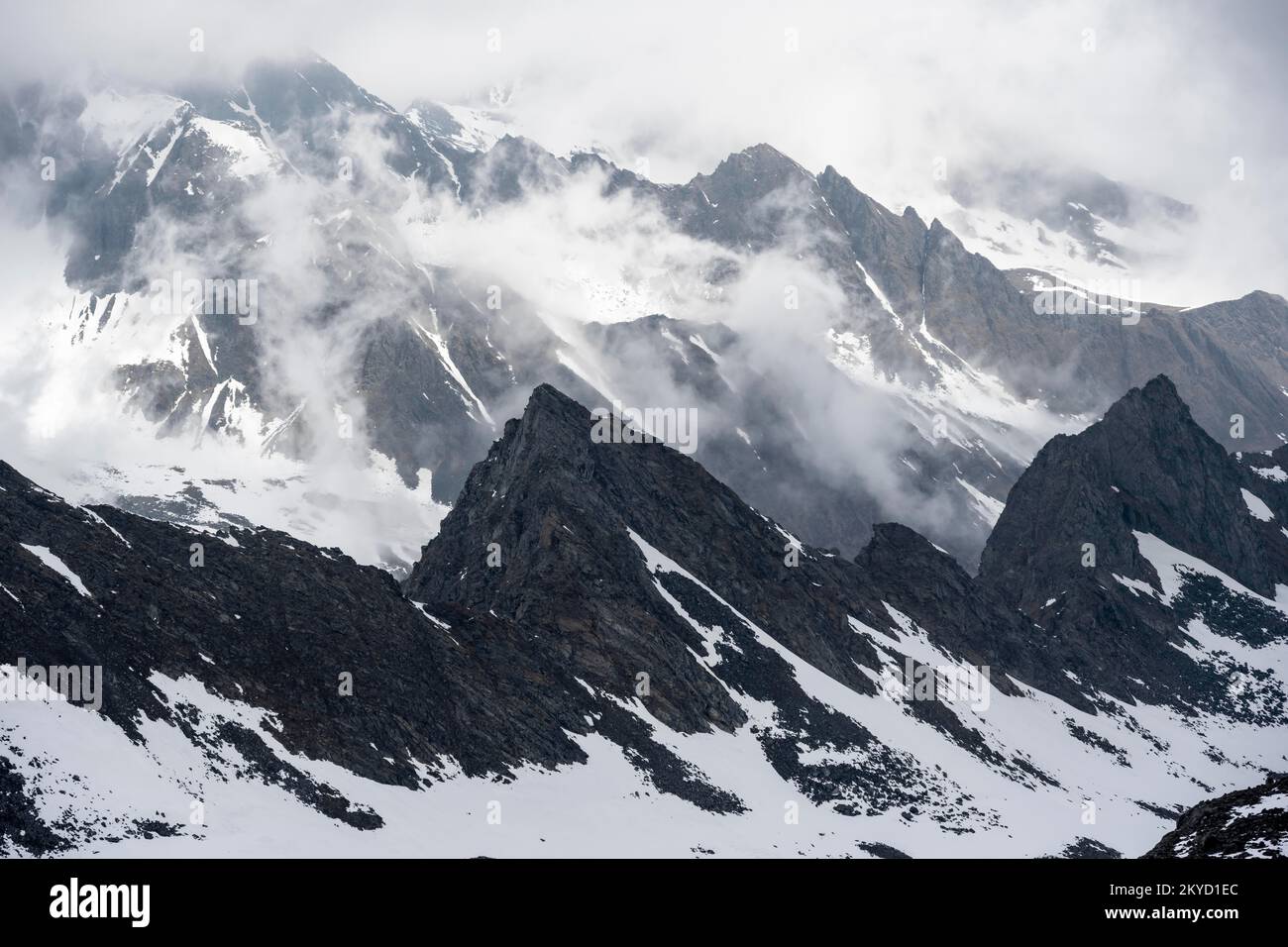 Mountains in winter with clouds and fog, Neustift im Stubai Valley, Tyrol, Austria Stock Photo