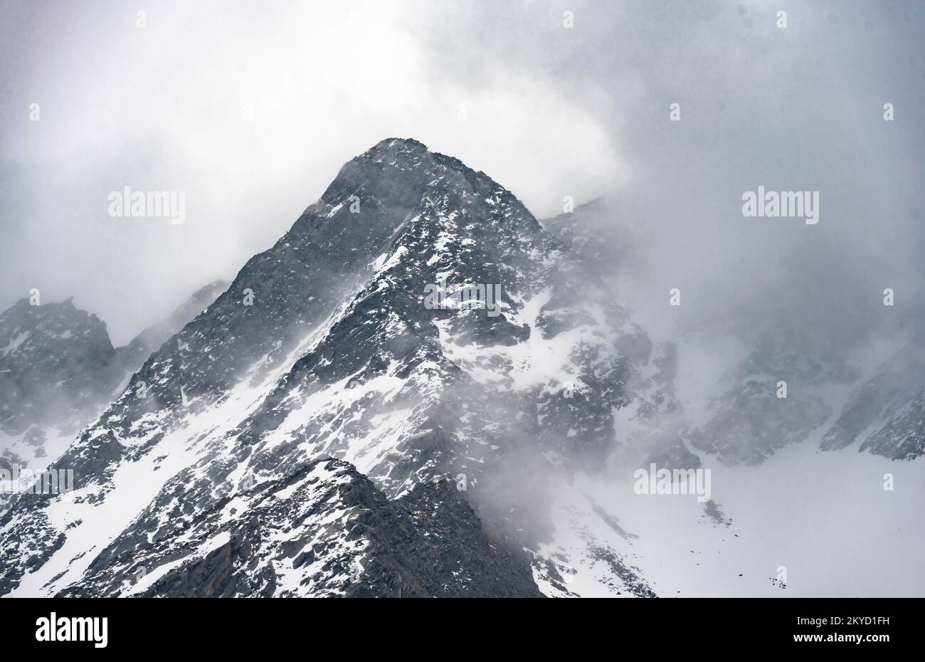 Mountains in winter with clouds and fog, Neustift im Stubai Valley, Tyrol, Austria Stock Photo