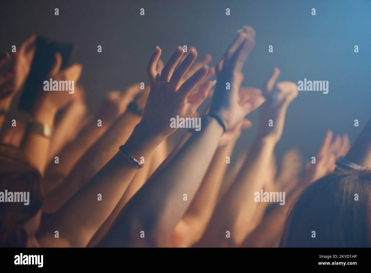 Feeling the music. An excited crowd raising their hands and reaching out to their favourite band. Stock Photo